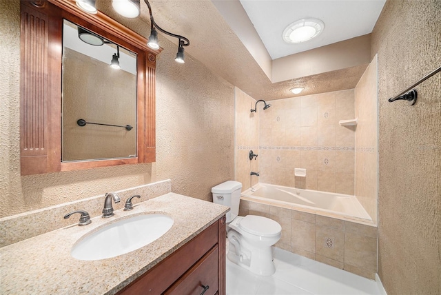 full bathroom with toilet, vanity, and tiled shower / bath