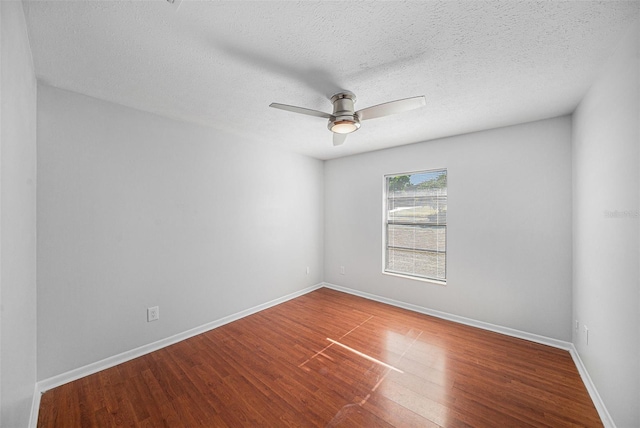 spare room with hardwood / wood-style flooring, ceiling fan, and a textured ceiling