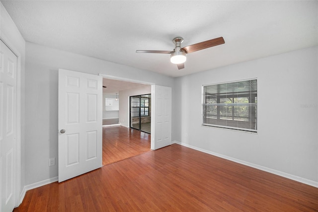 empty room featuring hardwood / wood-style flooring and ceiling fan