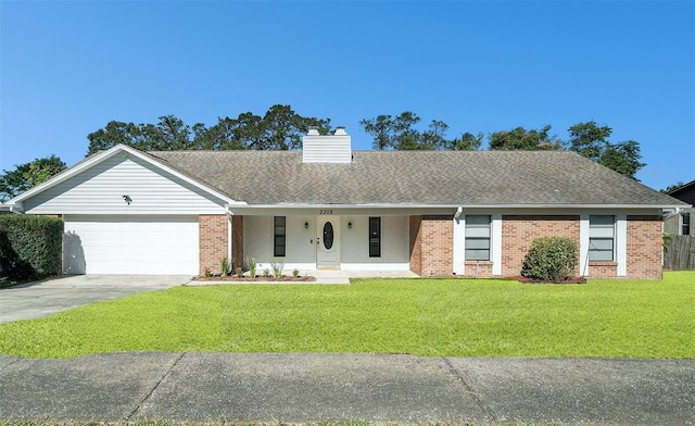 ranch-style house featuring a garage and a front lawn