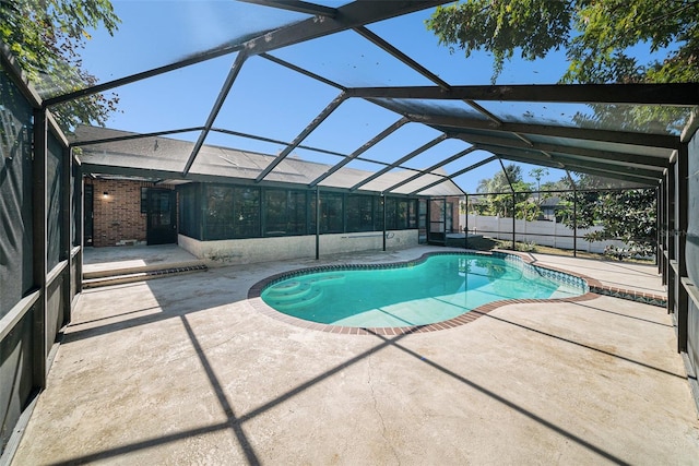 view of swimming pool with a patio and a lanai