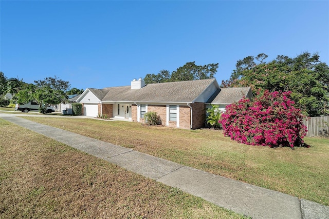 ranch-style house featuring a garage and a front yard