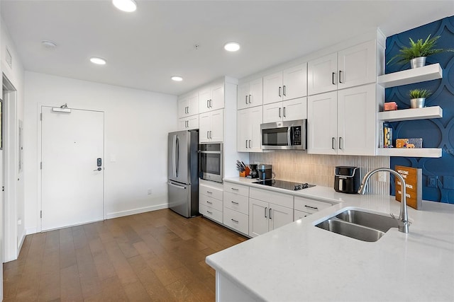 kitchen with sink, white cabinetry, appliances with stainless steel finishes, and tasteful backsplash