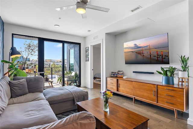 living room featuring ceiling fan and light hardwood / wood-style floors