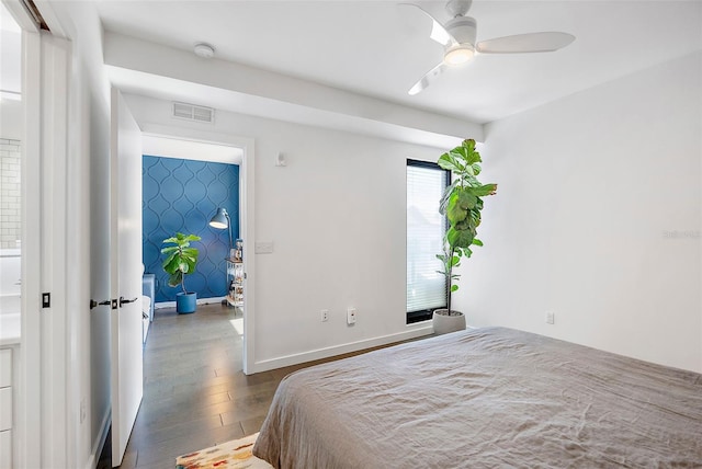 bedroom with ceiling fan and dark hardwood / wood-style floors