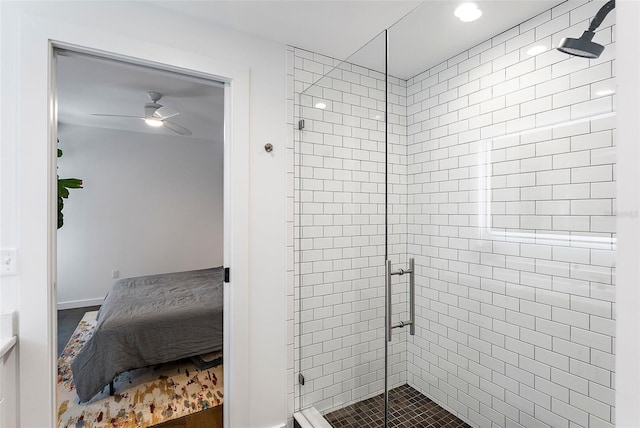 bathroom featuring a shower with shower door and ceiling fan