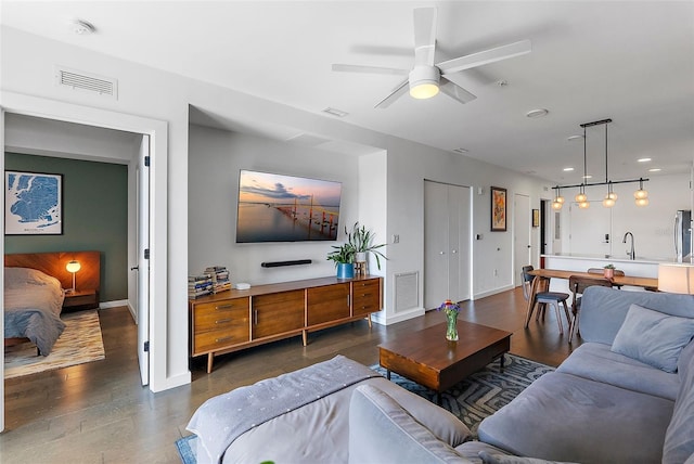 living room with ceiling fan and sink