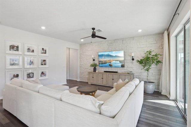 living room with ceiling fan and dark hardwood / wood-style flooring