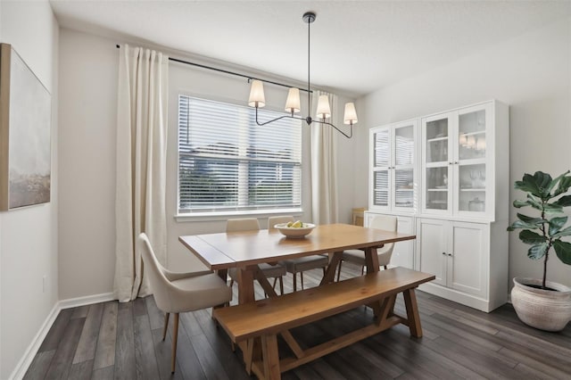 dining area featuring dark hardwood / wood-style flooring and a chandelier