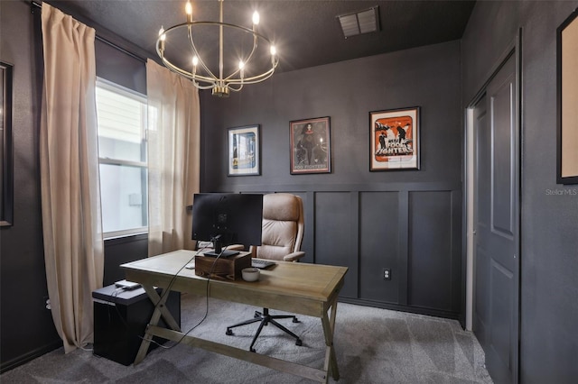 home office with carpet and a chandelier