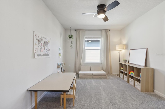 interior space with carpet flooring and ceiling fan