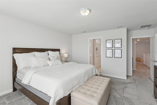 carpeted bedroom with ensuite bath