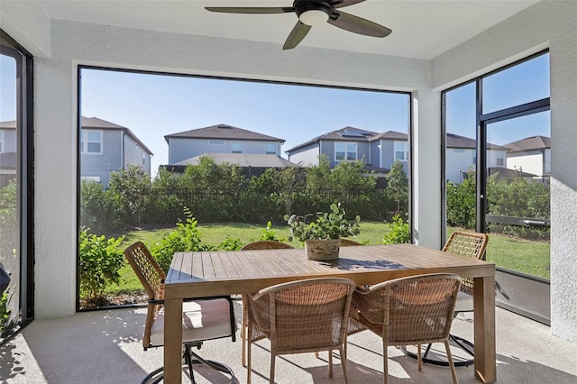 sunroom featuring ceiling fan