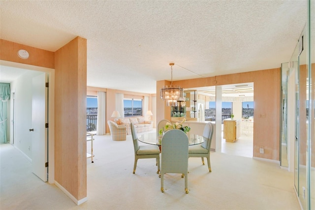 carpeted dining area with a textured ceiling and a notable chandelier