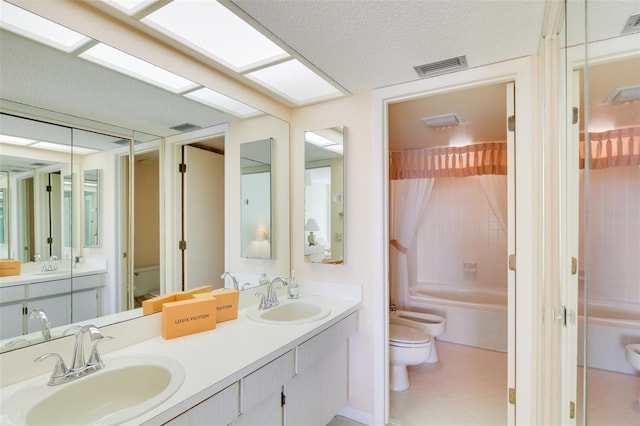 full bathroom featuring tile patterned floors, vanity, tiled shower / bath combo, a bidet, and toilet