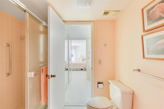 bathroom with an enclosed shower and toilet