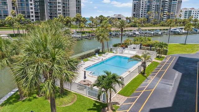 view of pool with a water view and a patio area