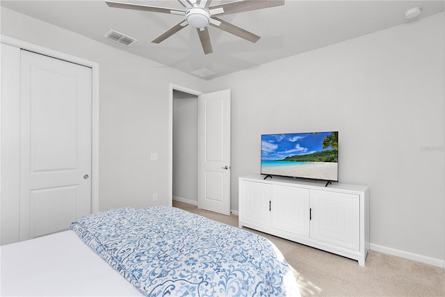 carpeted bedroom with a closet and ceiling fan