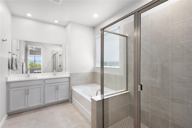 bathroom featuring tile patterned flooring, vanity, and separate shower and tub