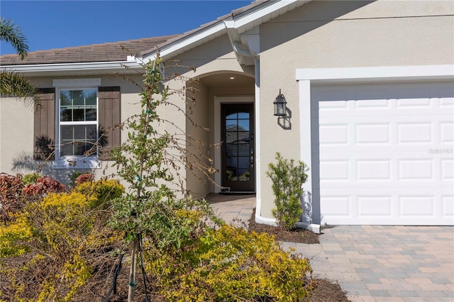 view of exterior entry featuring a garage