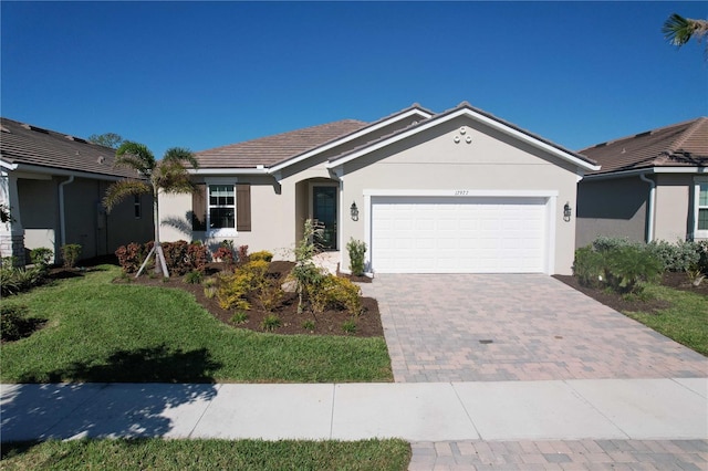 single story home featuring a garage and a front lawn