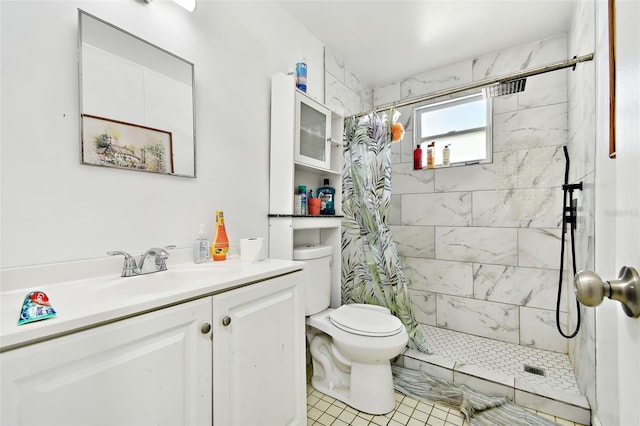 bathroom featuring tile patterned flooring, a shower with curtain, toilet, and vanity