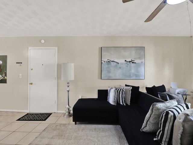 living room featuring ceiling fan and light tile patterned floors