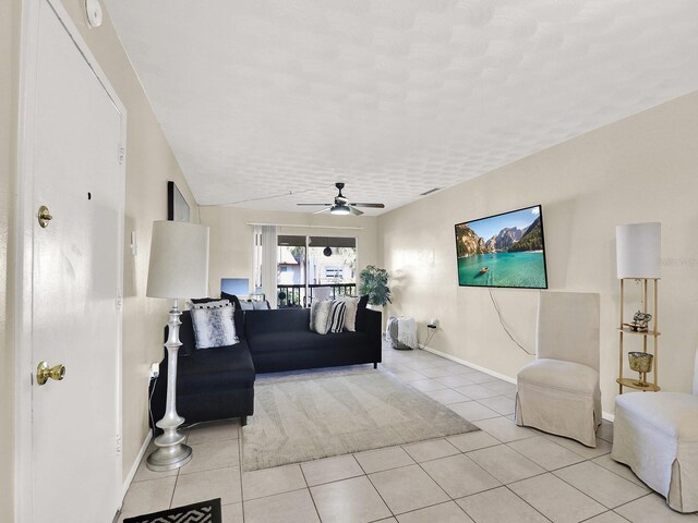 living room featuring light tile patterned floors and ceiling fan