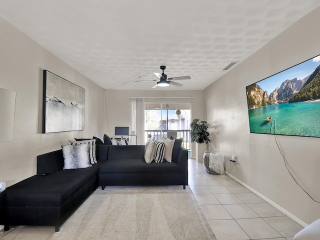 living room with ceiling fan and light tile patterned flooring