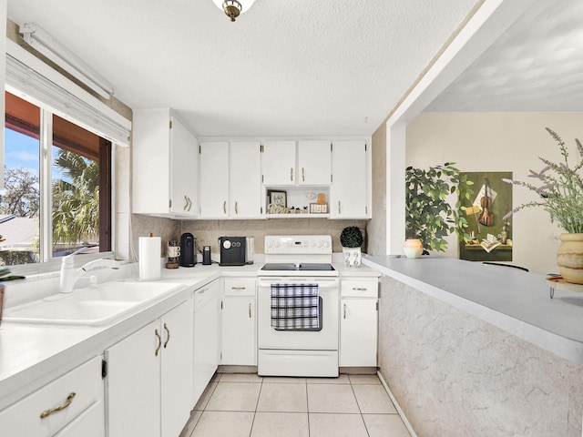 kitchen with white electric range, sink, light tile patterned floors, a textured ceiling, and white cabinetry