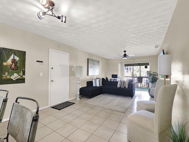 living room with ceiling fan with notable chandelier and light tile patterned flooring