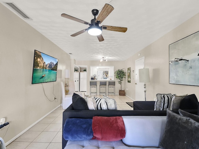 living room with ceiling fan and light tile patterned floors