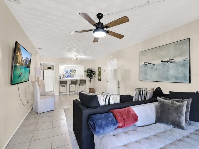 living room with ceiling fan and light tile patterned flooring