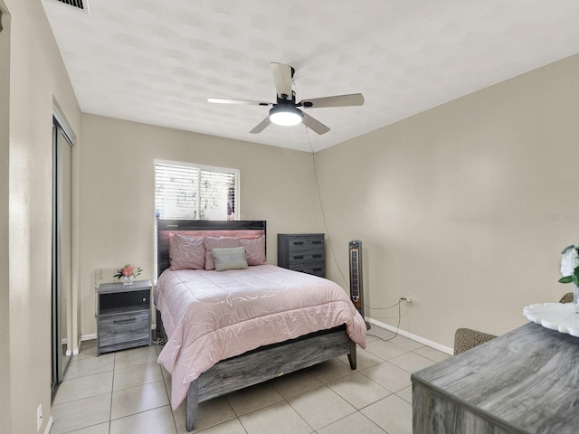 tiled bedroom with ceiling fan