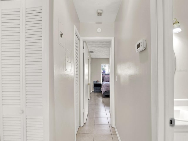 hall featuring light tile patterned floors