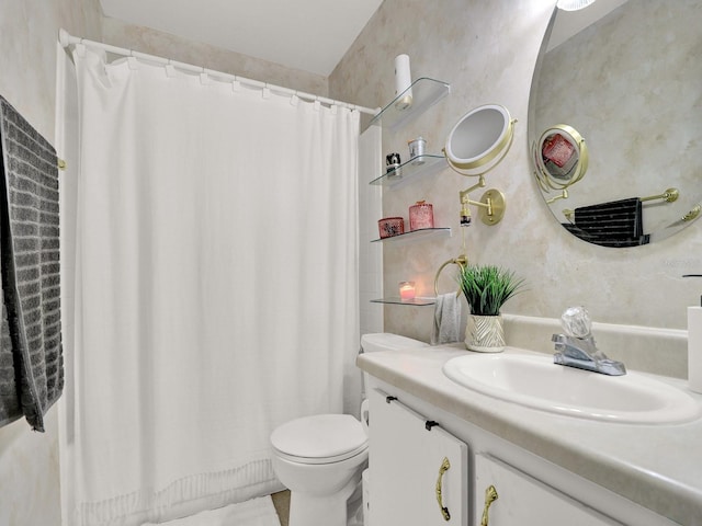 bathroom featuring a shower with shower curtain, vanity, and toilet