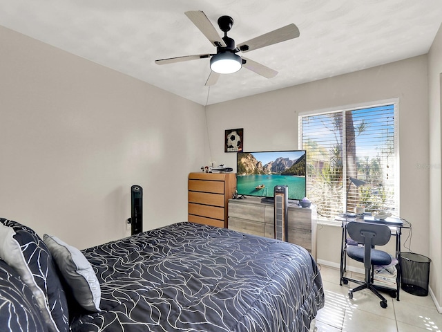 tiled bedroom featuring ceiling fan