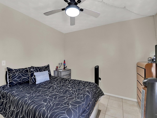 bedroom with ceiling fan and light tile patterned flooring