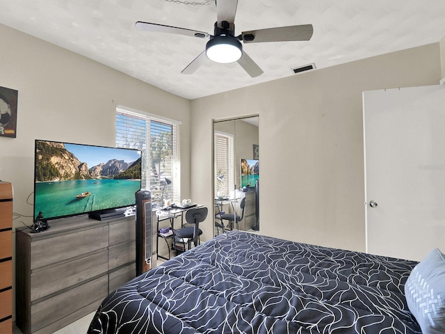 bedroom with ceiling fan and a closet