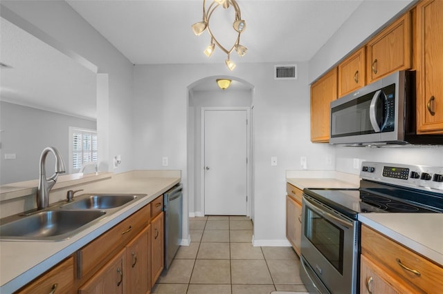 kitchen featuring light tile patterned flooring, stainless steel appliances, and sink