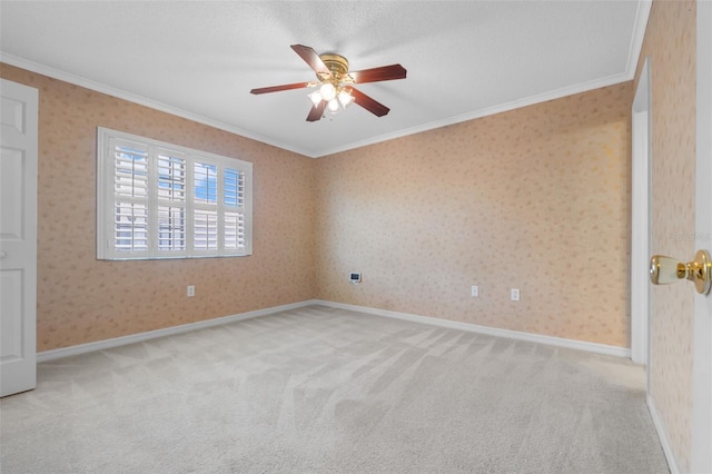 carpeted spare room featuring crown molding, ceiling fan, and a textured ceiling