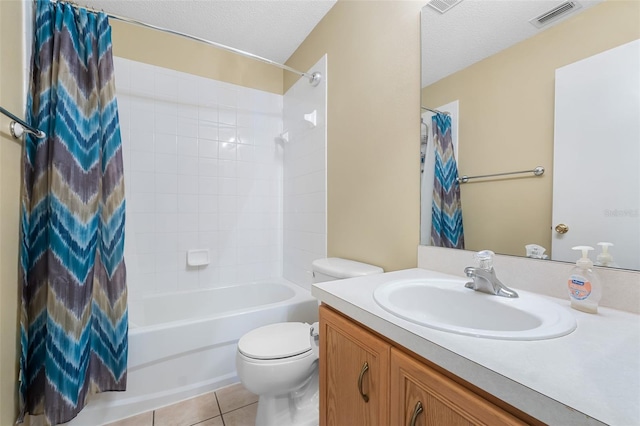 full bathroom featuring shower / bath combo, vanity, tile patterned flooring, toilet, and a textured ceiling