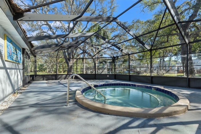 view of swimming pool featuring a patio area, a lanai, and an in ground hot tub