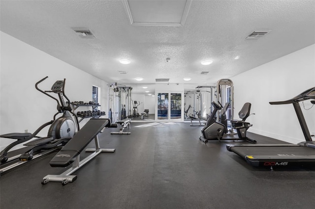 workout area with a textured ceiling