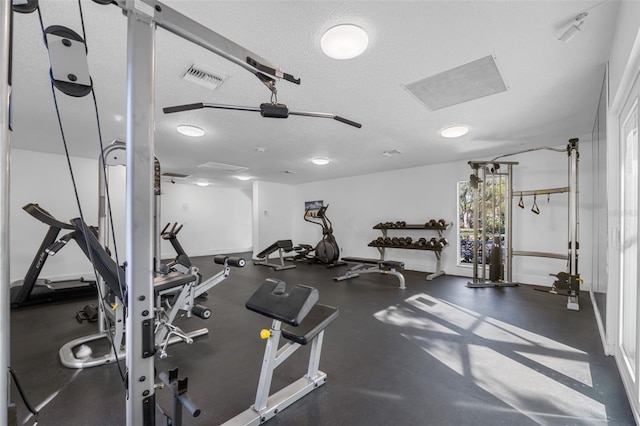 workout area featuring a textured ceiling