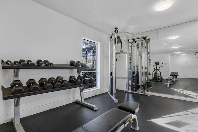 workout area featuring a textured ceiling