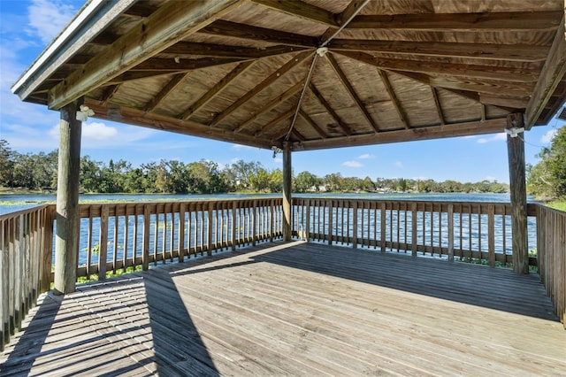 view of dock featuring a deck with water view and a gazebo