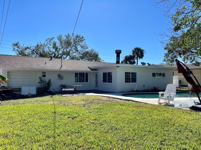 rear view of property featuring a lawn