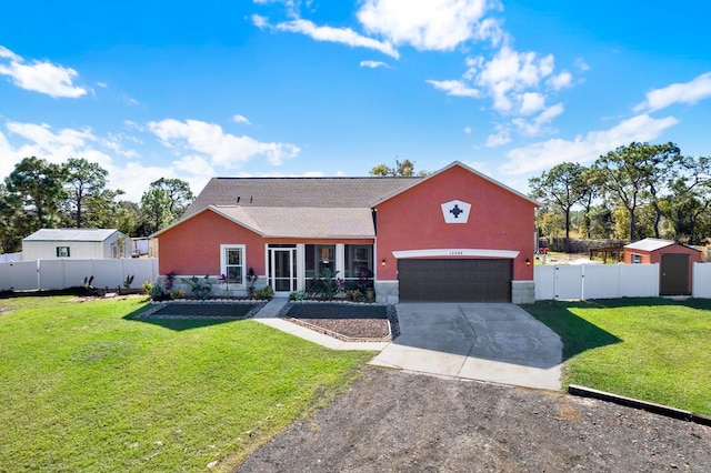 view of front of house with a sunroom, a front yard, and a garage