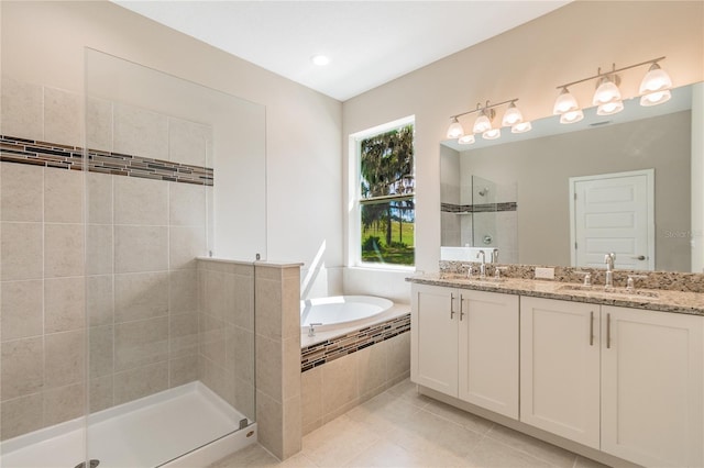 bathroom featuring tile patterned floors, vanity, and shower with separate bathtub